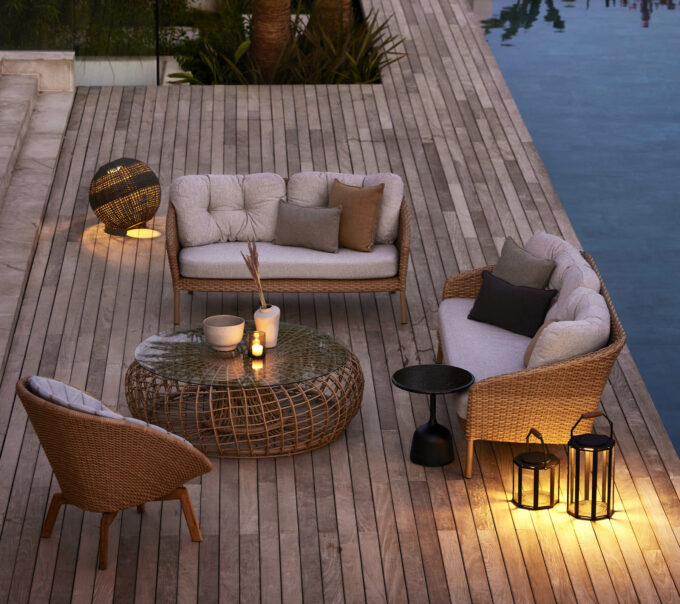 Ocean Large-Sofa kombiniert mit einem Peacock Loungesessel und Nest- und Glaze-Tisch, sowie Illusion Lampe alles von Cane-line.
